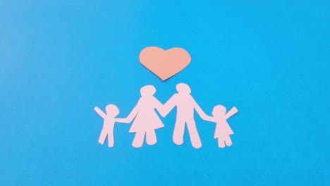 happy family figure with love sign zoom in. world health day protection against domestic violence, healthcare and medical background. foster care, homeless support and social distancing concept.