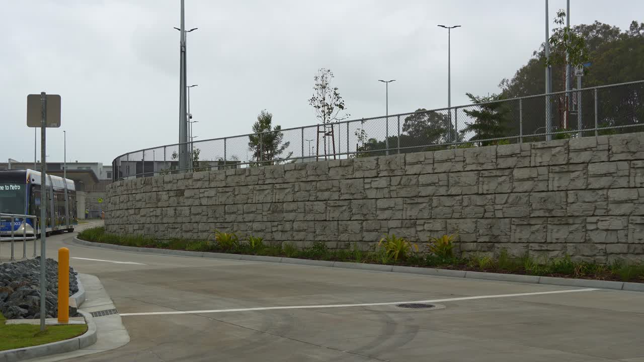 Brisbane Metro bus driving around Rochedale depot, an innovative bus rapid transit system in Queensland.