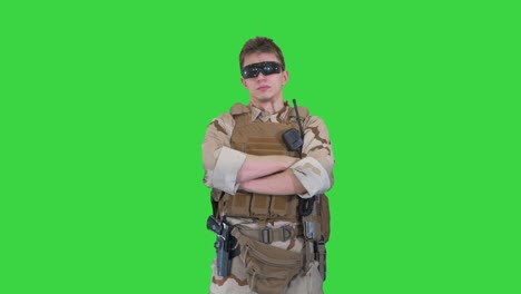 us marine ranger with folded arms on a green screen, chroma key