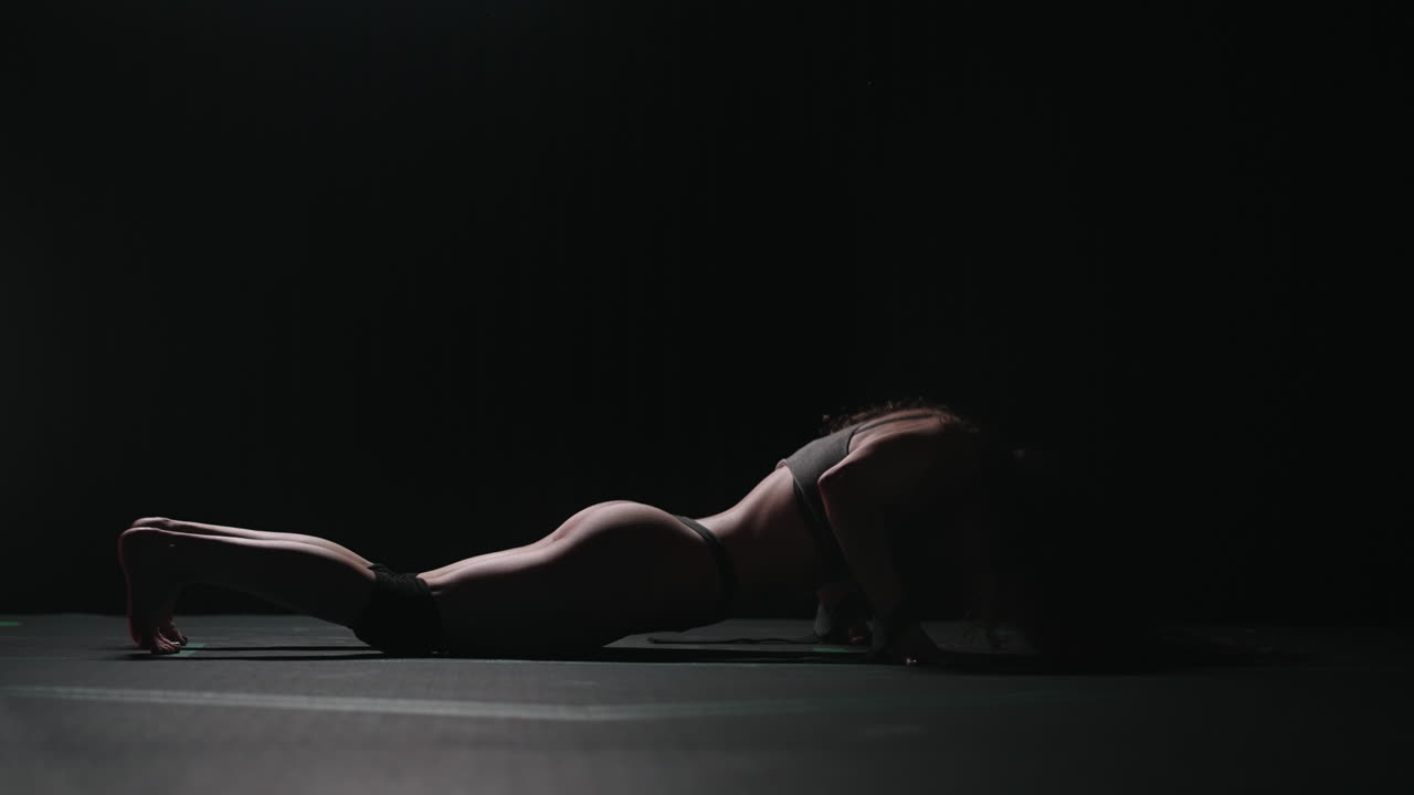 A young beautiful sexy woman dances beautifully in the gym. Modern choreography in the gym. Dancer