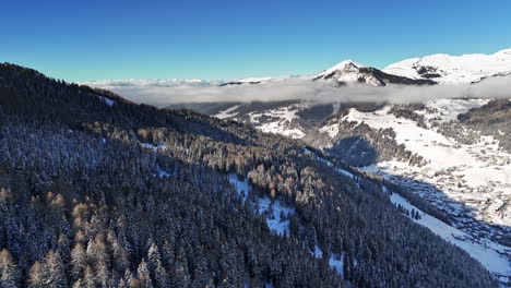 snowy mountain landscape with trees and clouds