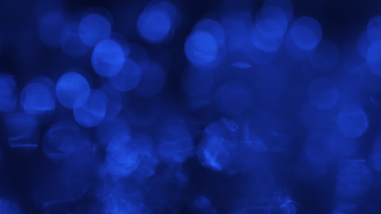 Movimento astratto di luci blu sfocate. Bokeh blu lampeggiante e ondeggiante