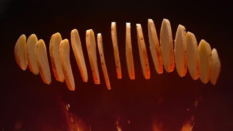 baking crisps - unpeeled potato jumps above the flames and splits into slices