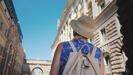 stockholm sweden a female tourist with a swedish flag goes to the arch near the parliament one of th