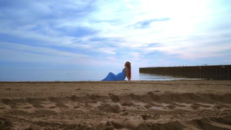 Mujer-Tumbada-En-La-Playa-Del-Mar-Con-Vestido-Azul.-Mujer-Embarazada-Relajándose-En-La-Playa