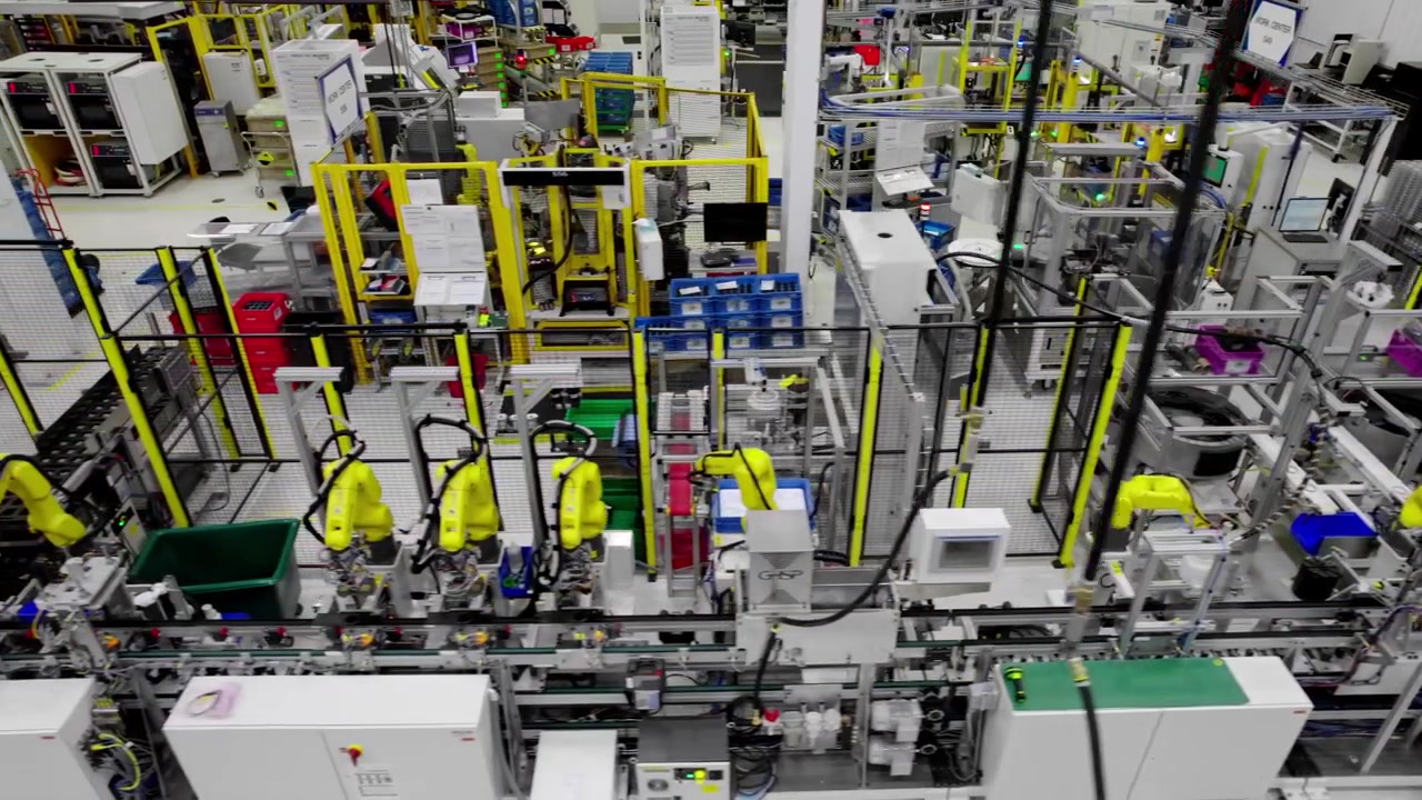 Advanced modern machinery in tech factory, wide high angle slide shot