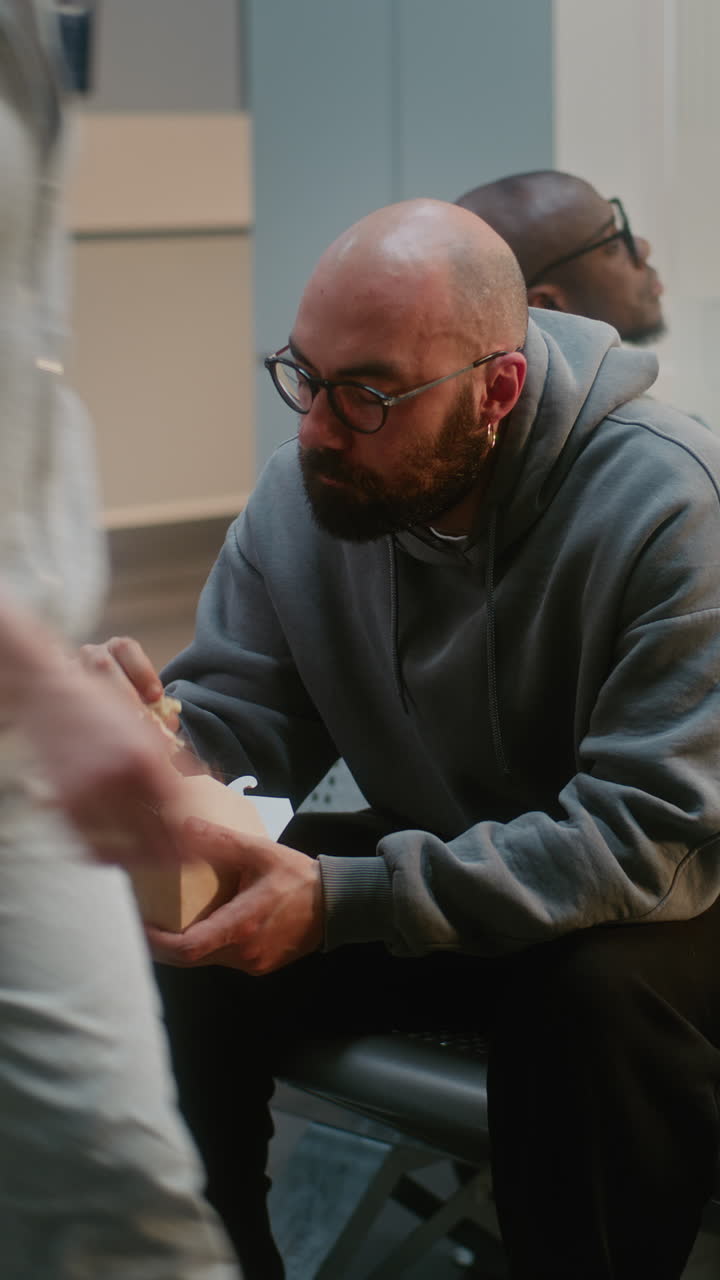 Man Eating Lunch in a Hospital Waiting Room