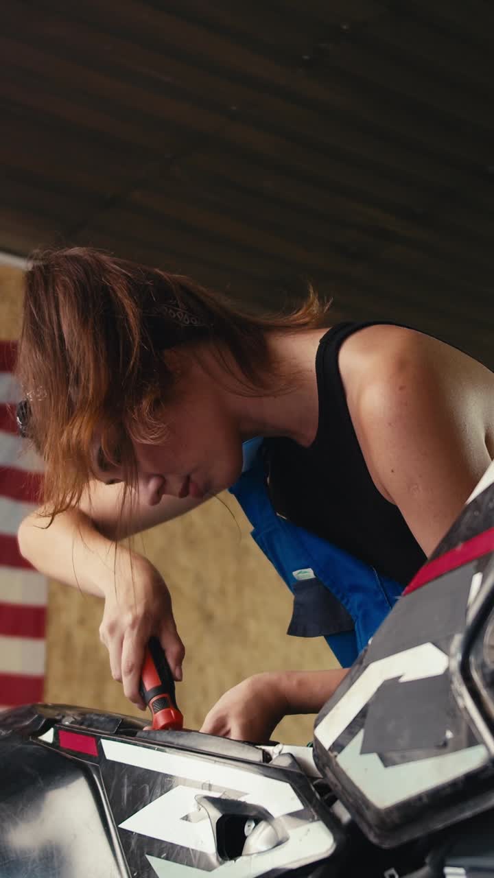 Woman repairing a motorcycle