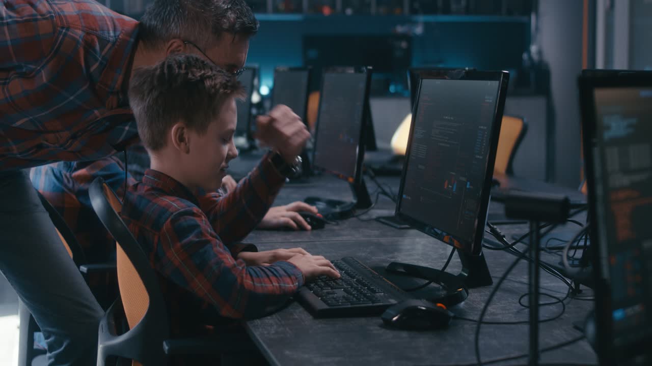 Boy and Teacher Learning Computer Programming