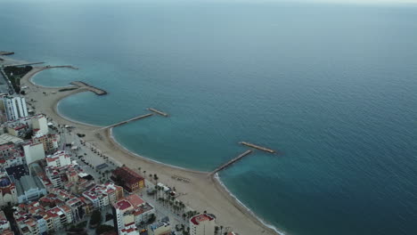 aerial view of coastal town with beach and bay