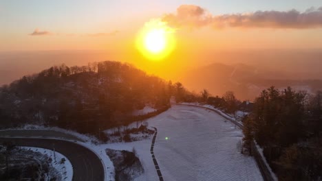 sunrise aerial push in with snow in blowing rock nc, north carolina