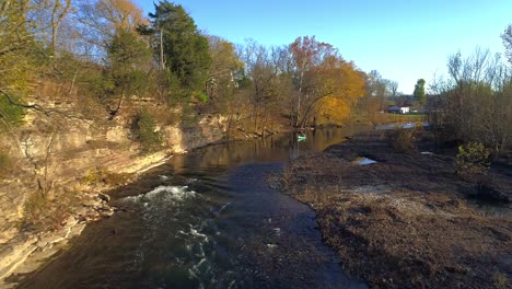 Aerial-shot-flying-over-a-creek-heading-toward-person-in-canoe