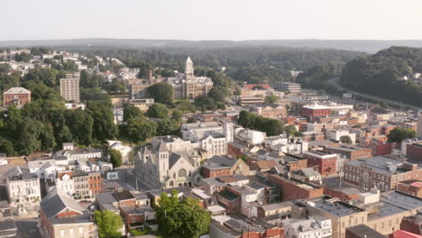 aerial drone shot flying over a small town in central pennsylvania heading towards a historic courthouse on a sunny morning