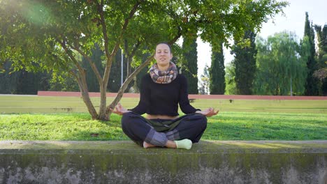 yoga teacher laughing and talking in lotus position, at the end she smile