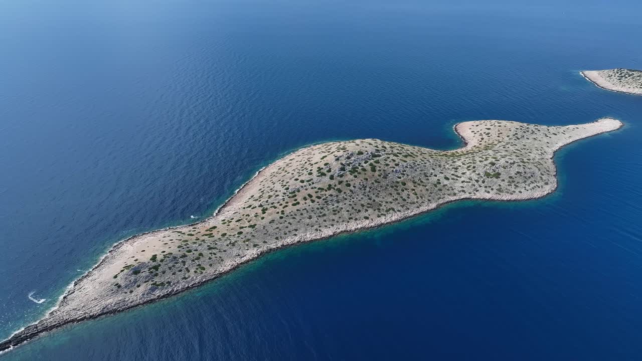 Aerial panoramic orbit Kornati National Park, revealing rugged terrain and isolated islands with sparse vegetation in deep blue sparkling water, establishing, Croatia