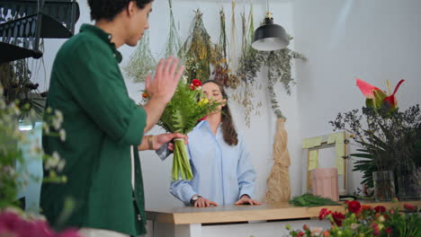 african customer buy flower bouquet. flower shopper say goodbye to florist woman