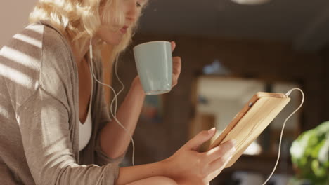 beautiful blonde woman at home using digital tablet technology