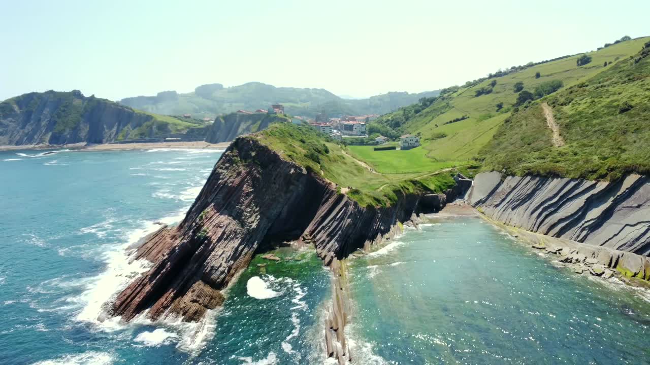 Coastal landscape with unique rock formations and green hills