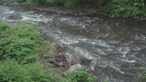 The-Wissahickon-Creek,-high-angle,-flowing-over-rocks-and-stones