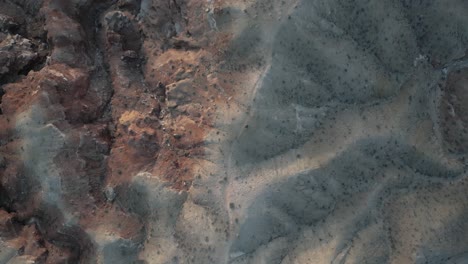 Desert-landscape-with-rugged-terrain-viewed-from-above-in-rising-shot,-Utah,-USA