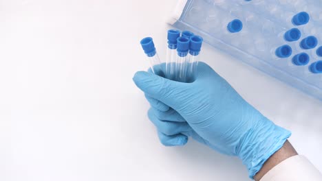 scientist holding test tubes in lab