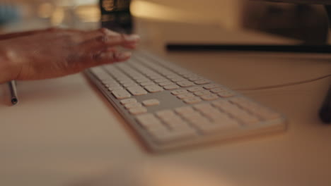 Hands-typing-at-night,-keyboard