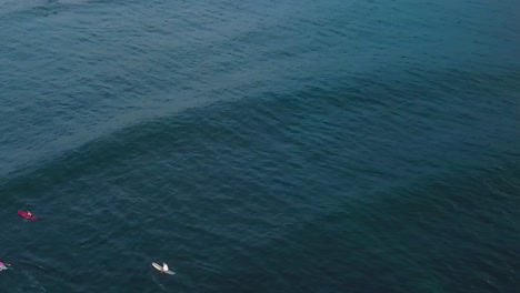 drone aerial waves sunset surfers on ocean