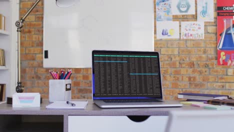 Laptop-with-data-processing-standing-on-desk-in-office