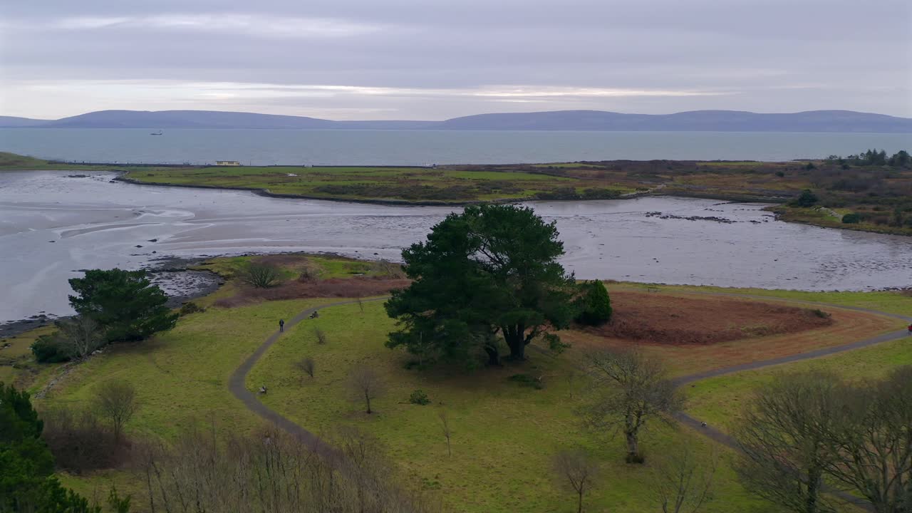 Aerial dolly shot flying over Rusheen Bay park in Barna, Galway, Ireland