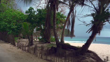 mahe seychelles small coastal road drive towards the far south of the island, road is very narrow and reached a beautiful but rough beach