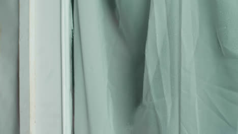 woman looking out a window on a rainy day