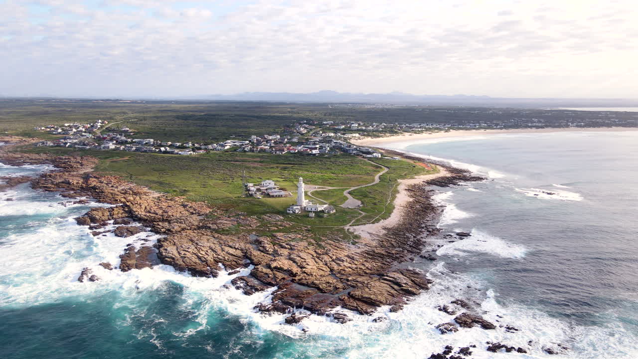 Drone tilt-up reveal iconic Seal Point lighthouse on headland of Cape St Francis