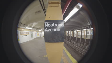 handheld shot of the nostrand avenue subway station. shot with a fish-eye lens in brooklyn, new york city.