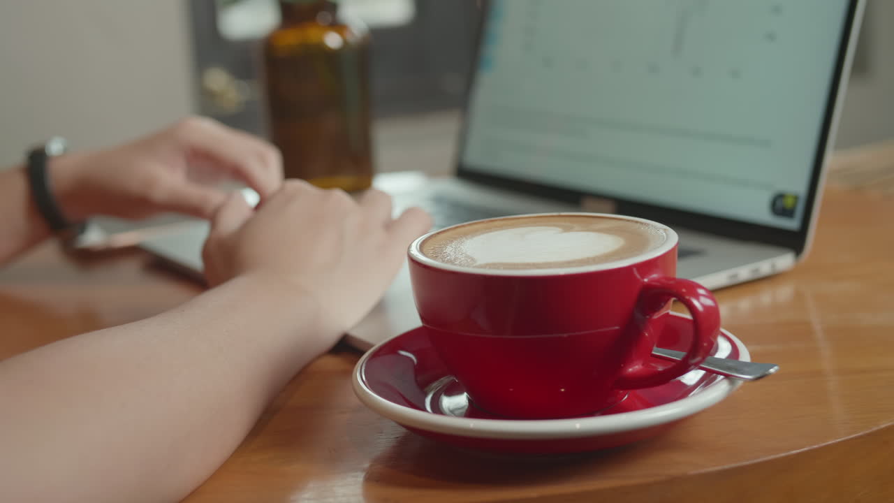 Using Laptop With A Cup Of Coffee