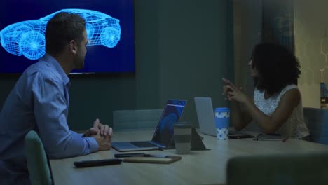 young office executives discussing over laptop in a modern office