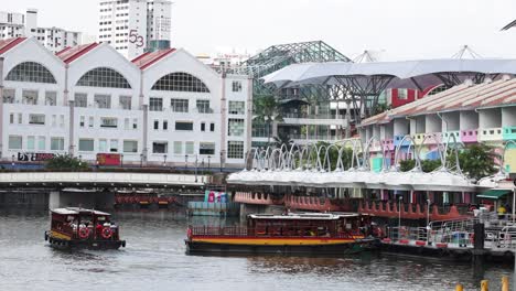 tourist boat cruising along a city riverfront.