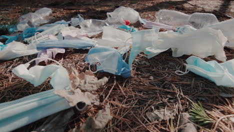 the wind blows on a pile of garbage with medical masks