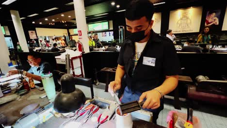 a smith peddling the burner and melting the gold in a workspace