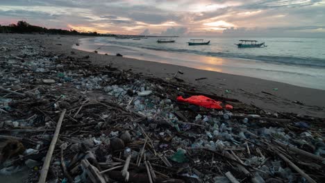 plastic pollution on a beach at sunset