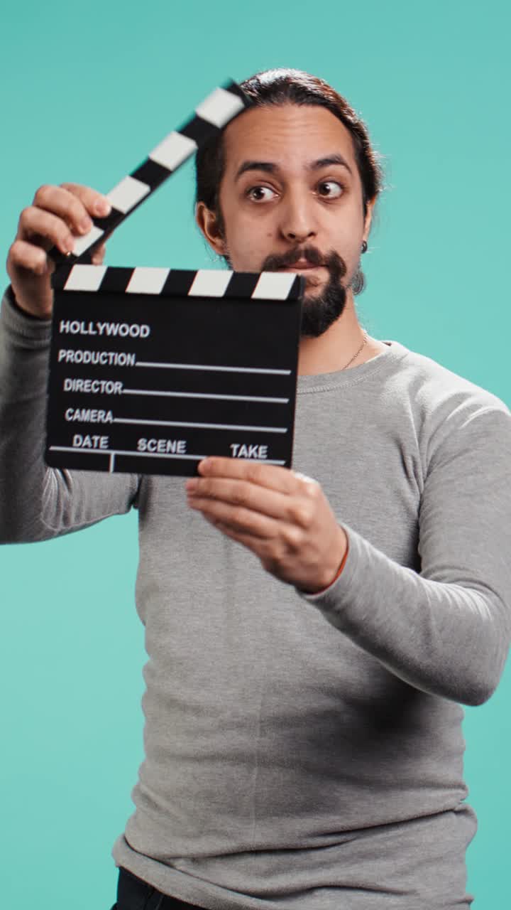 Vertical video Movie director using clapper on set, filming video production
