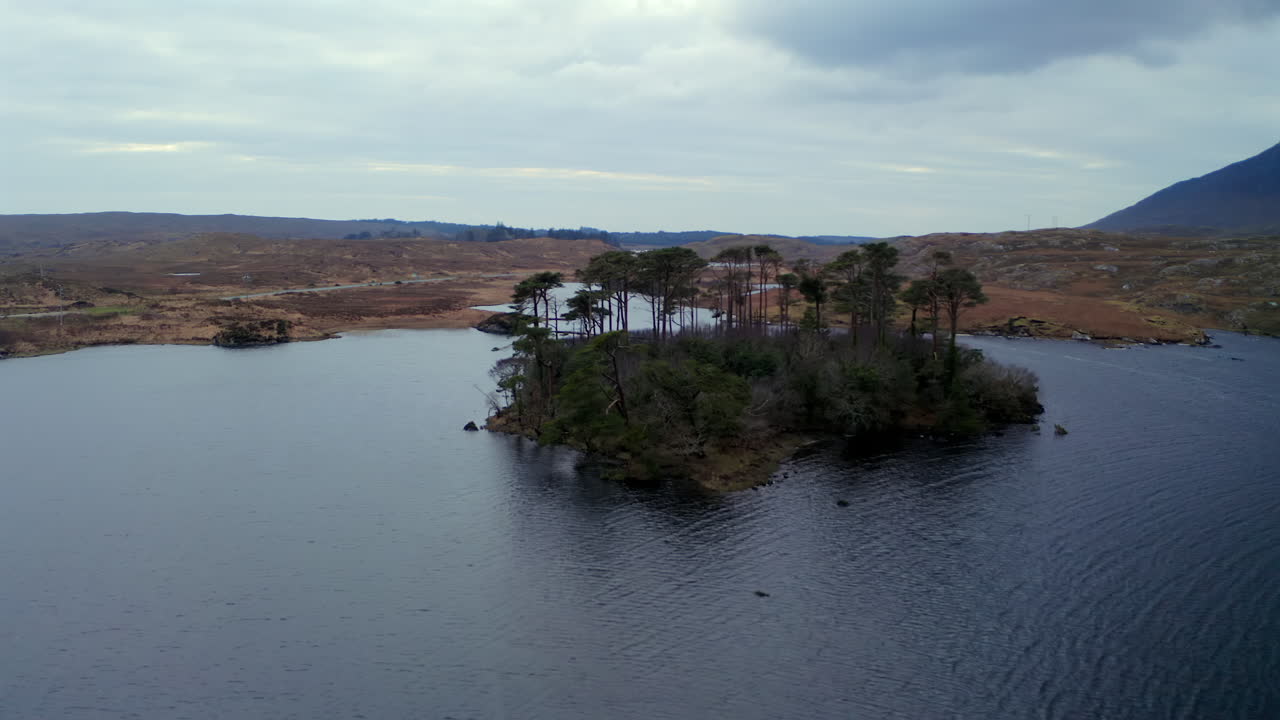 Wide establishing aerial of Derryclare Lough at twilight, capturing Connemara’s dramatic beauty, Galway