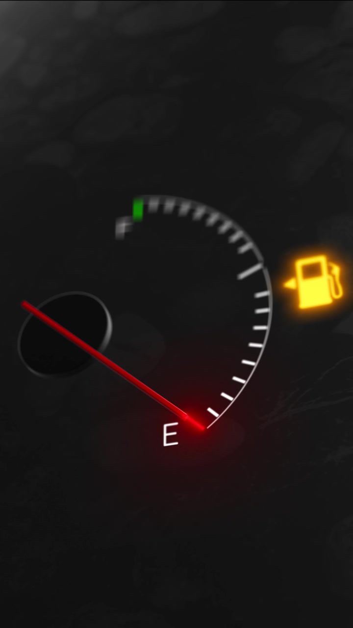 Low fuel dashboard indicator visual with dark speedometer style red pointer and glowing gas pump