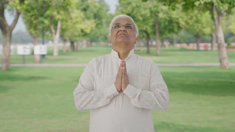 Religious-Indian-old-man-praying-to-God-in-park