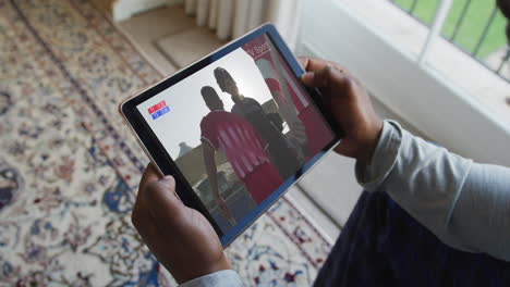 composite of man sitting at home, watching sports event on tablet