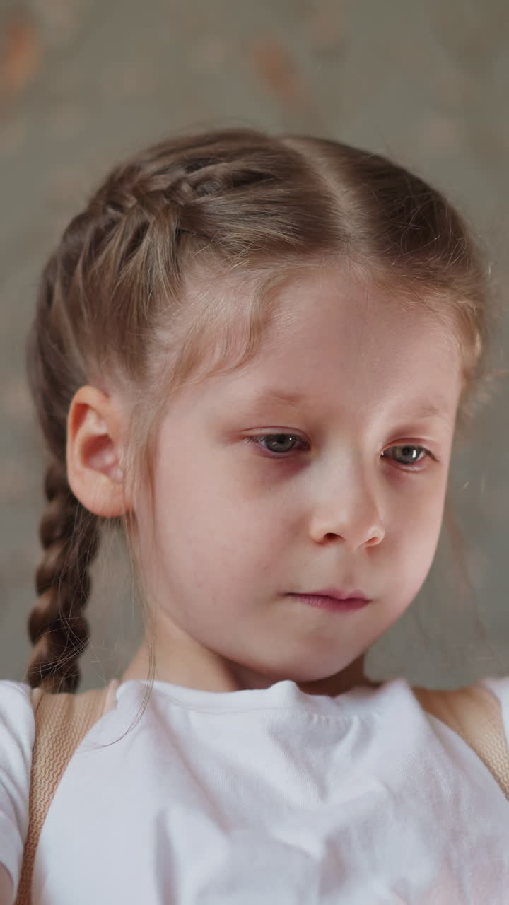 Schoolgirl finishes playing piece of music on piano. Child removes hands from instrument smoothly and looks into distance dreamily close low angle shot