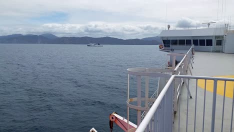 the view from a ferry as another interislander ferry sails past in the cook strait of new zealand