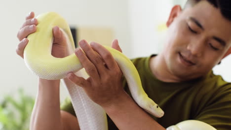 man holding snake indoors