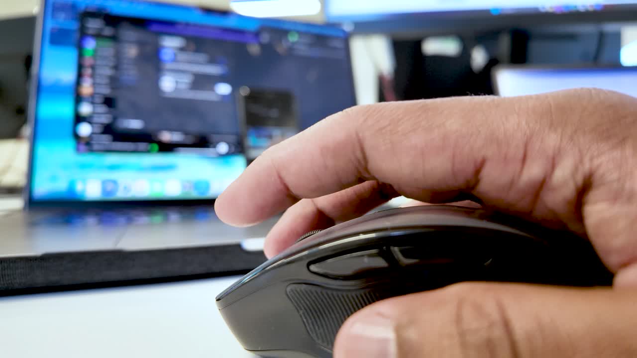 Close Up Of Finger Pressing Black Mouse Button With Laptop In Background For Online Gaming Or Remote Work Technology And Connectivity Concepts