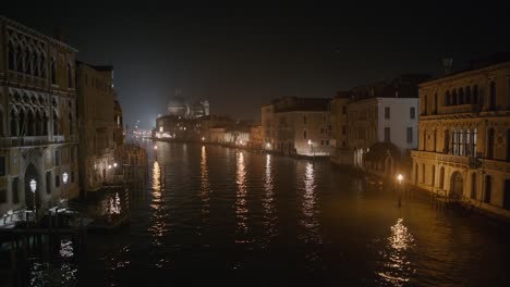 venetian canal by nightlight glow, italy