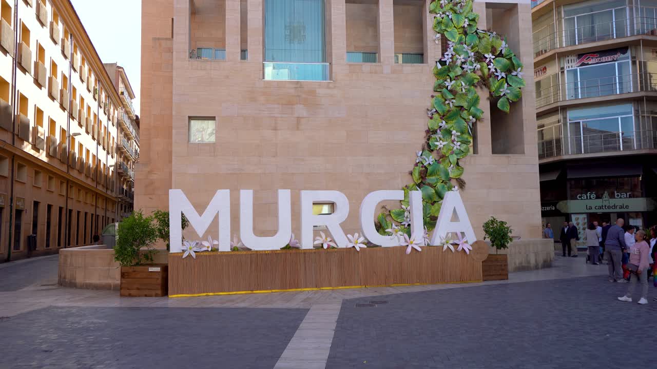 Letters with the name of the city of Murcia. Located in the historic center of the city in Cardenal Belluga Square. Stabilized footage. People. Travel destination in Spain